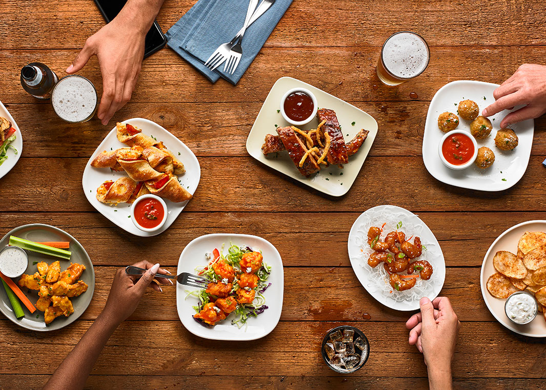 Photo of promotional items including wings, ribs, chips, and other appetizers