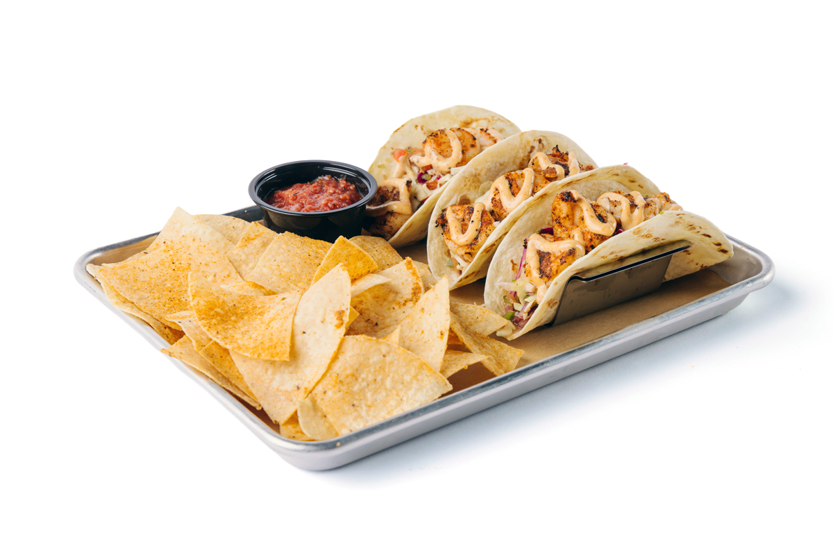 image of our baja shrimp tacos with our side of tortilla chips and a side of salsa
