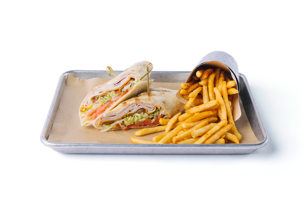 image of our club wrap with a side of fries on a silver tray