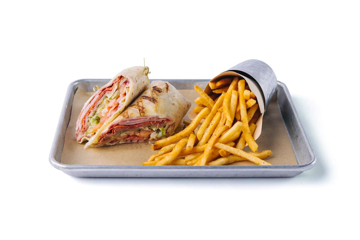 image of our italian brute wrap with a side of fries on a silver tray