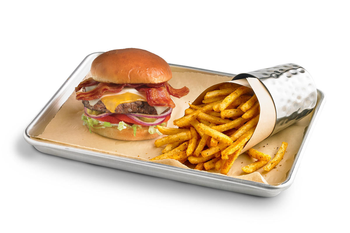 The Most Valuable Burger, served on a sheet pan with seasoned fries.