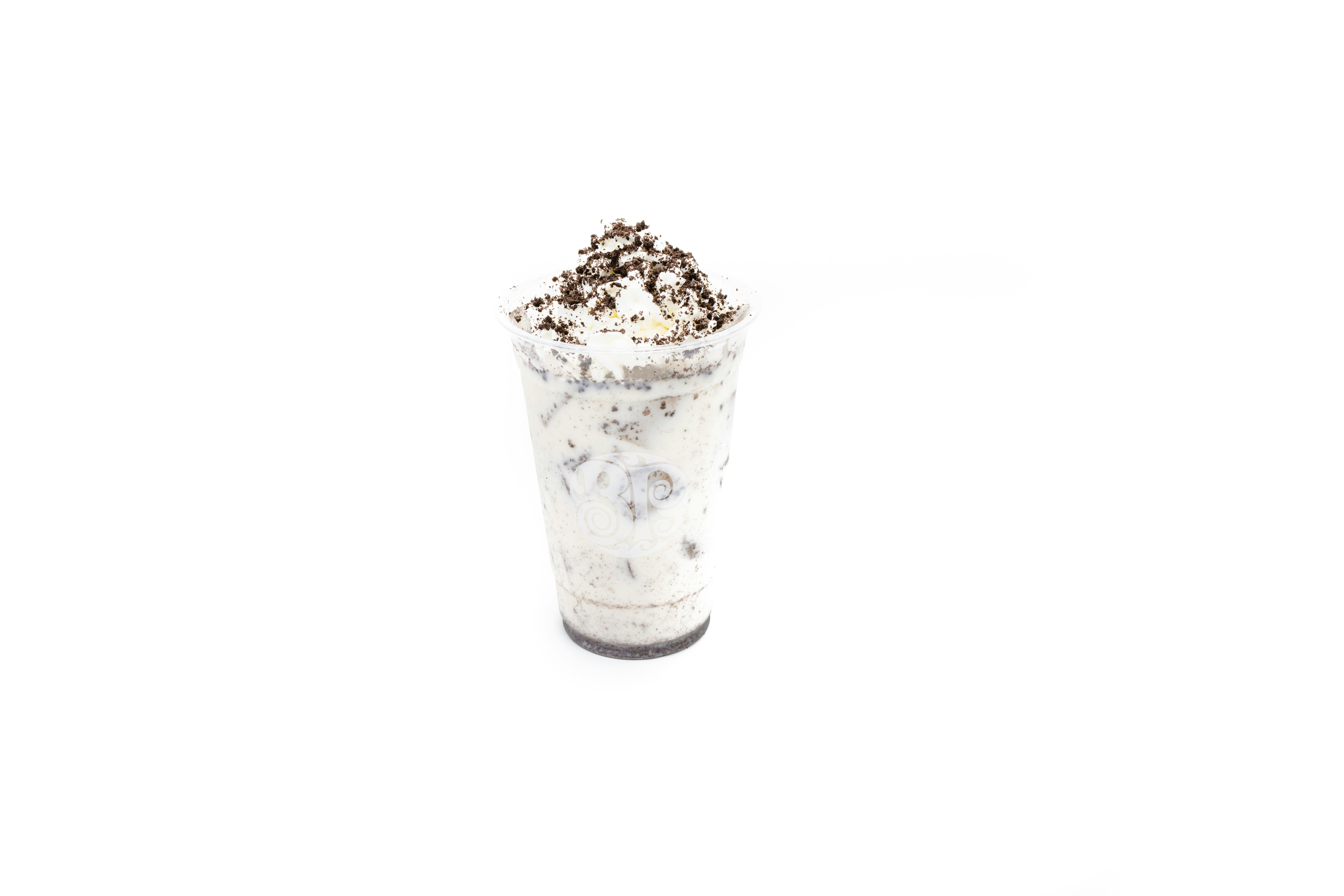 Image of oreos in cup, shaken with milk, topped with whipped cream and more oreos.