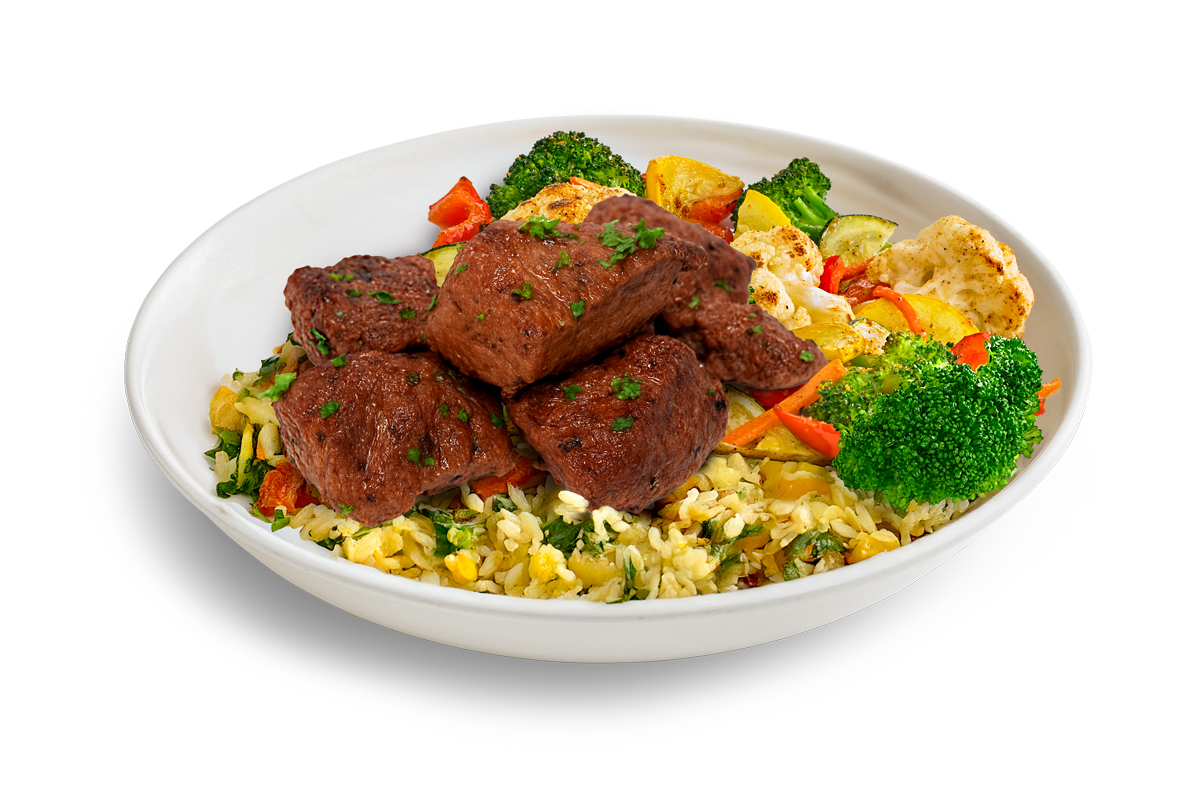 photo of steak bowl on top of florentine rice and some broccoli