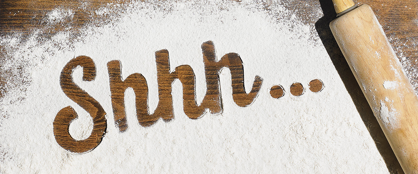 words sshh..spelled in flower on a wooden background