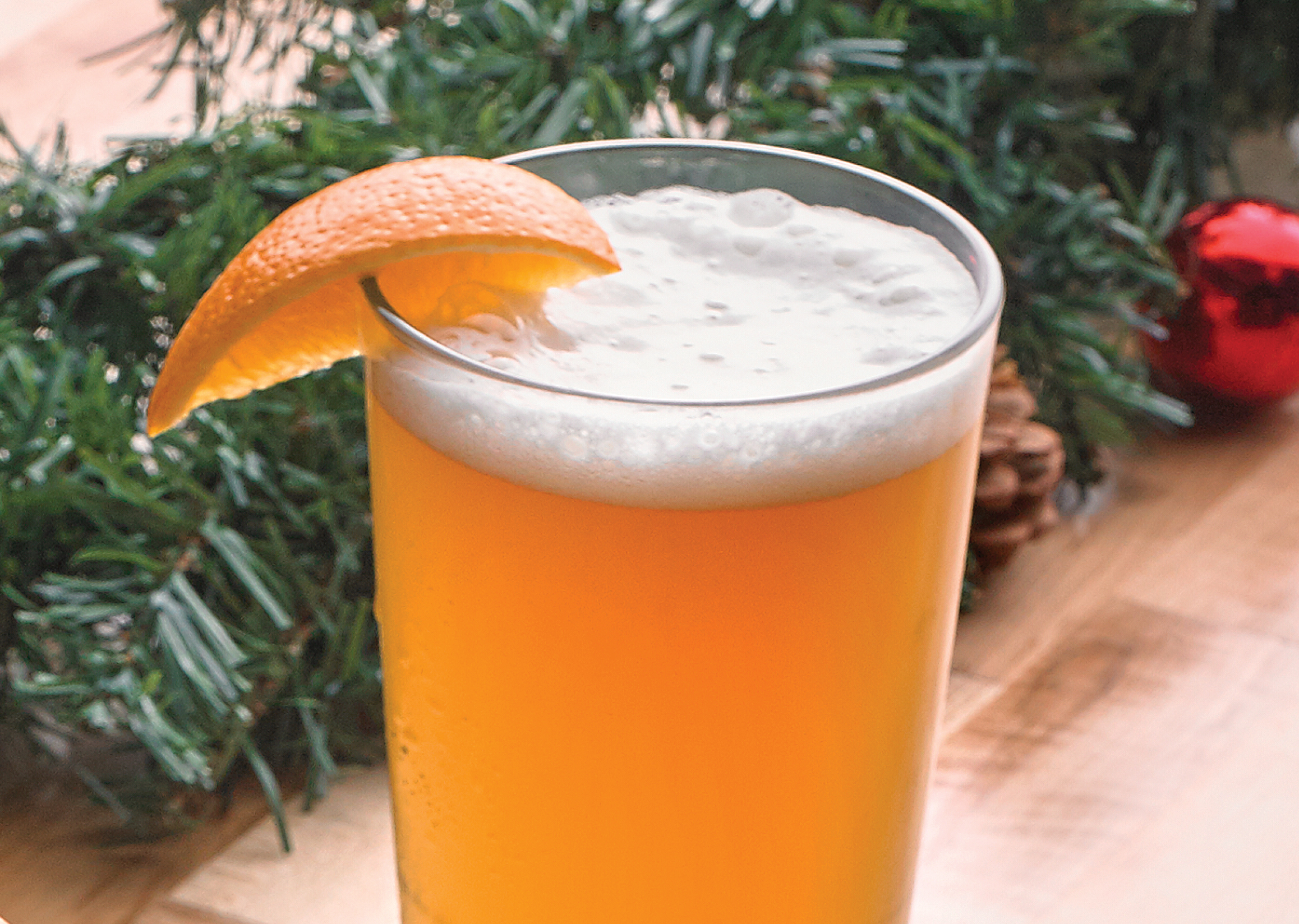 blue moon beer with an orange slice on a wood table.