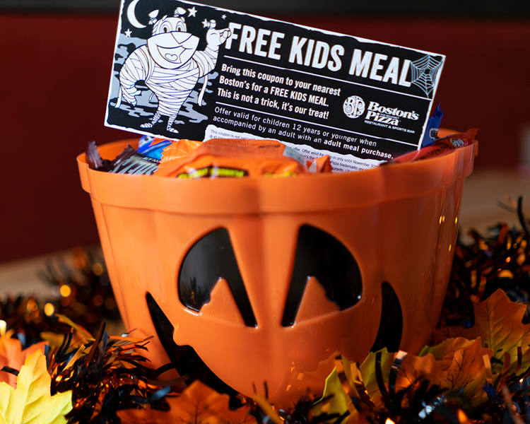 A free kids meal coupon inside a pumpkin candy holder. 