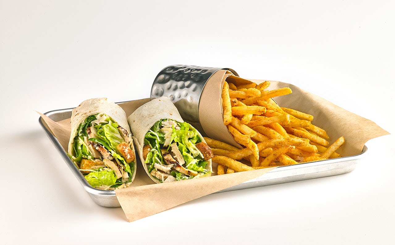 Photo of Chicken caesar wrap with fries.